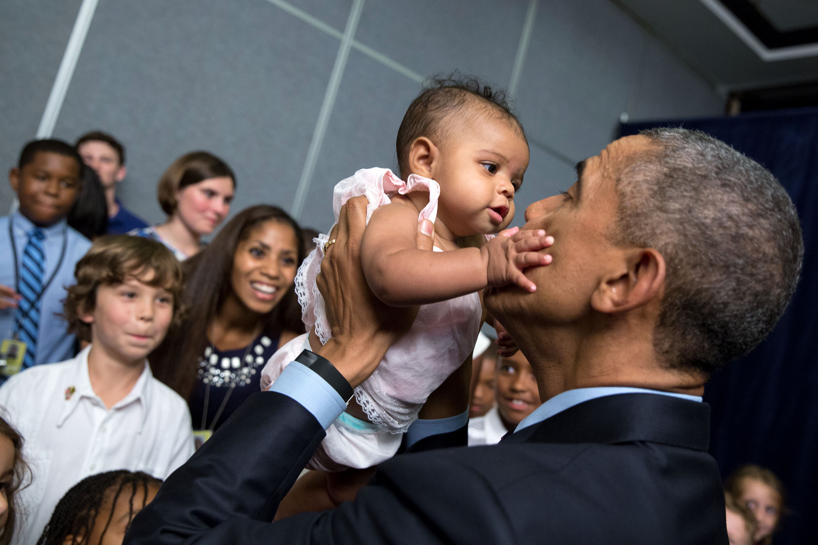 The President greets the daughter of an embassy worker. (Official White House Photo by Pete Souza)