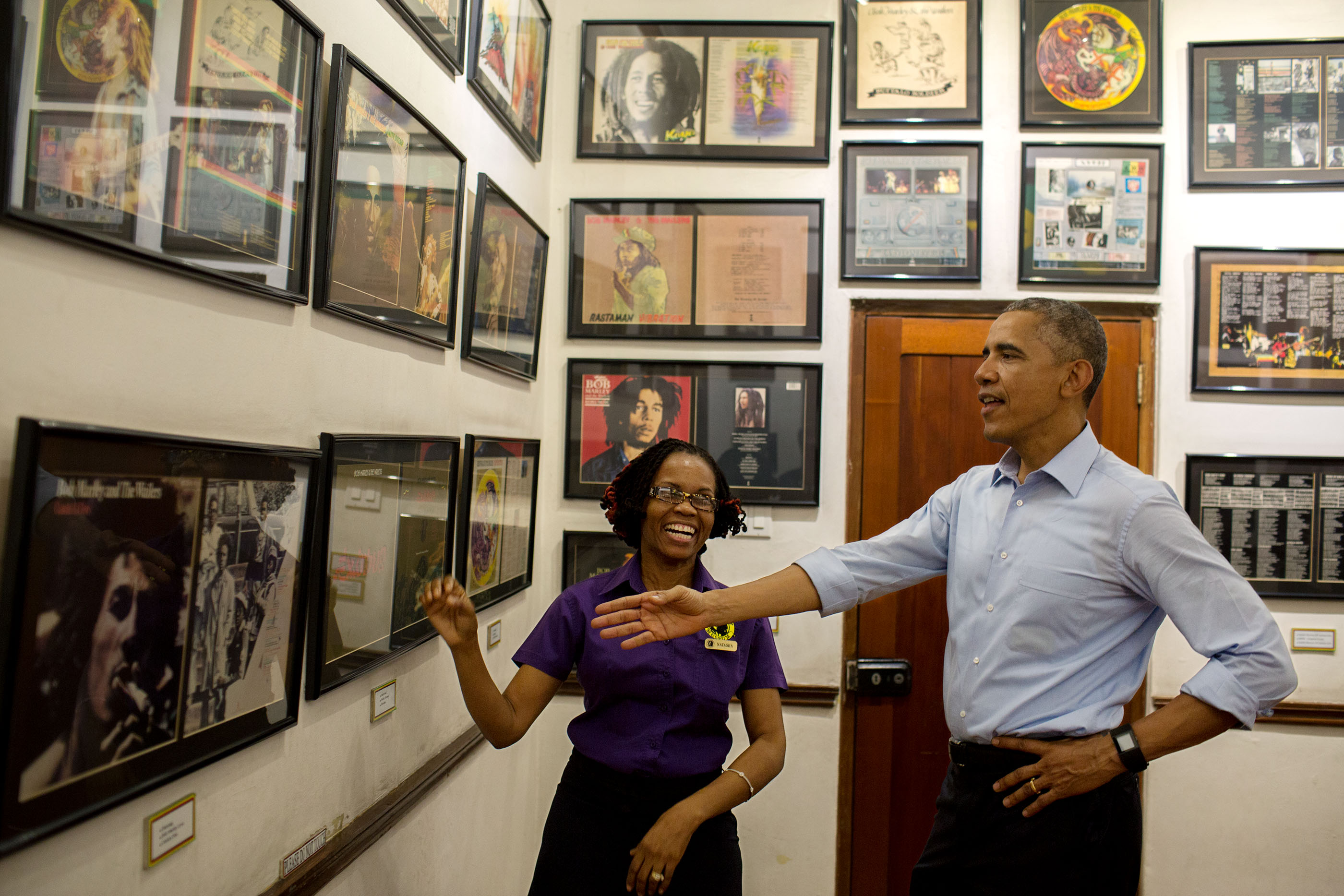 The President looks at memorabilia at the Bob Marley Museum during a tour with Natasha Clark.  (Official White House Photo by Pete Souza)