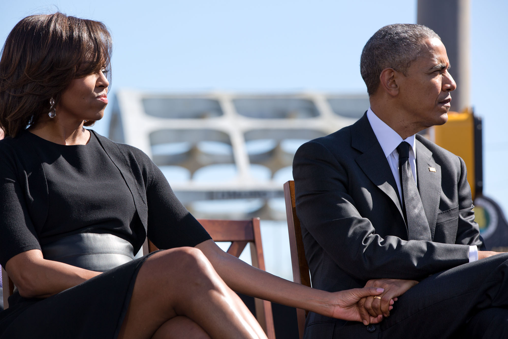 The President and First Lady hold hands as they listen to Rep. John Lewis speak at the ceremony. (Official White House Photo by Pete Souza)