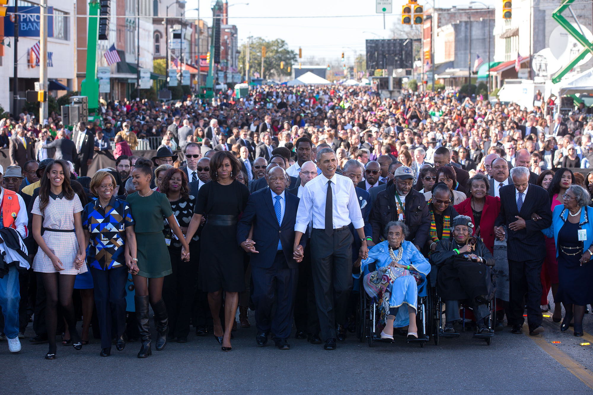 The Obama family join hands as they begin the march with the foot soldiers across the Edmund Pettus Bridge. (Official White House Photo by Lawrence Jackson)