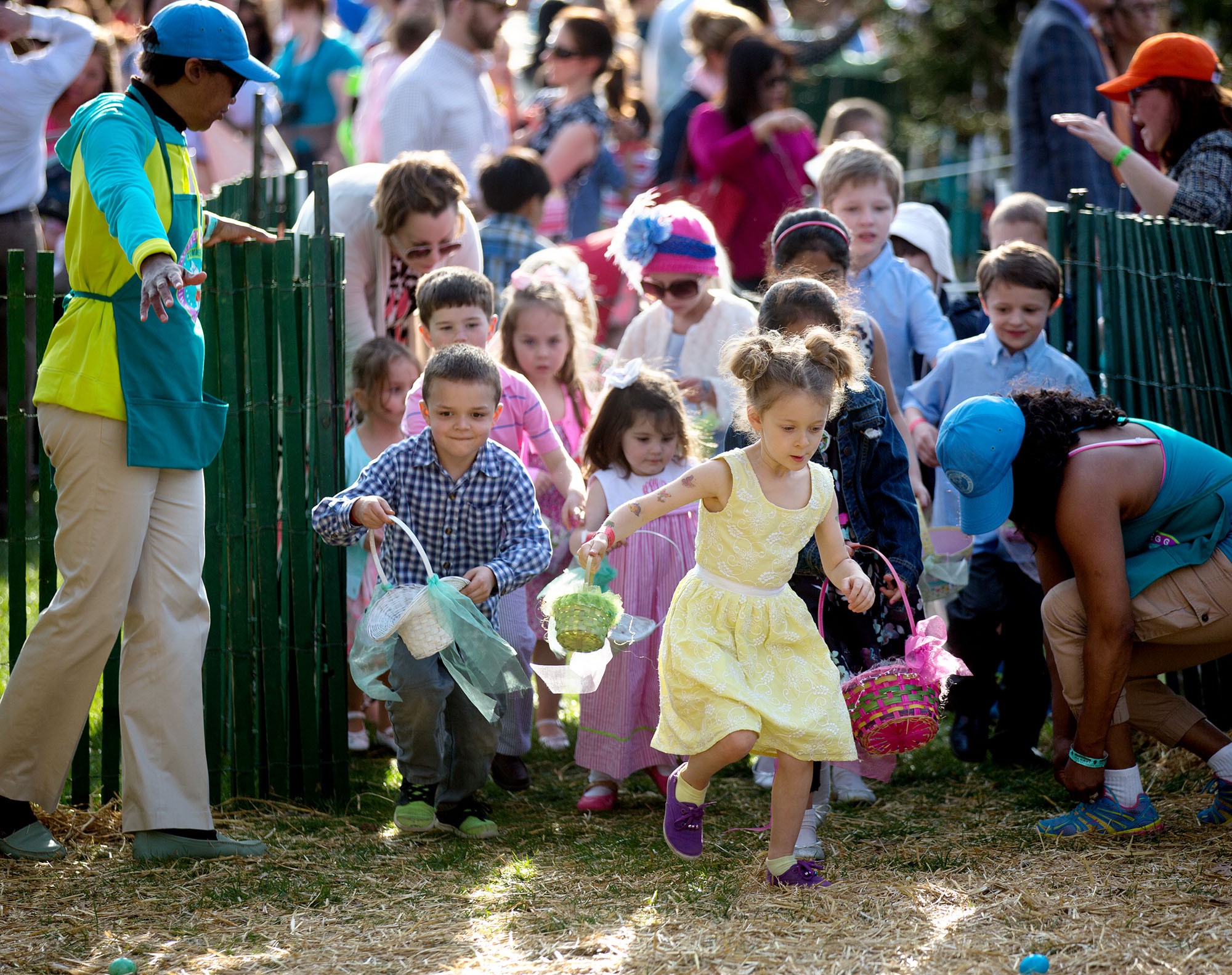 Children rush through the open gate in search of eggs. (Official White House Photo by Lawrence Jackson)