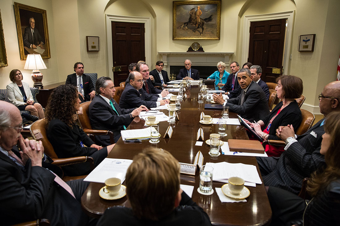 President Barack Obama drops by a 100,000 Strong in the Americas education roundtable in the Roosevelt Room of the White House, May 5, 2014.