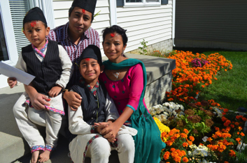 Sanjita poses for a family photo with her husband Bhushan Pradhan and two sons