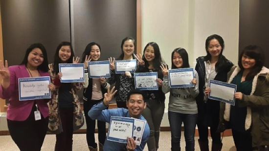 Students at Johns Hopkins University pose with their photo campaign about the importance of education