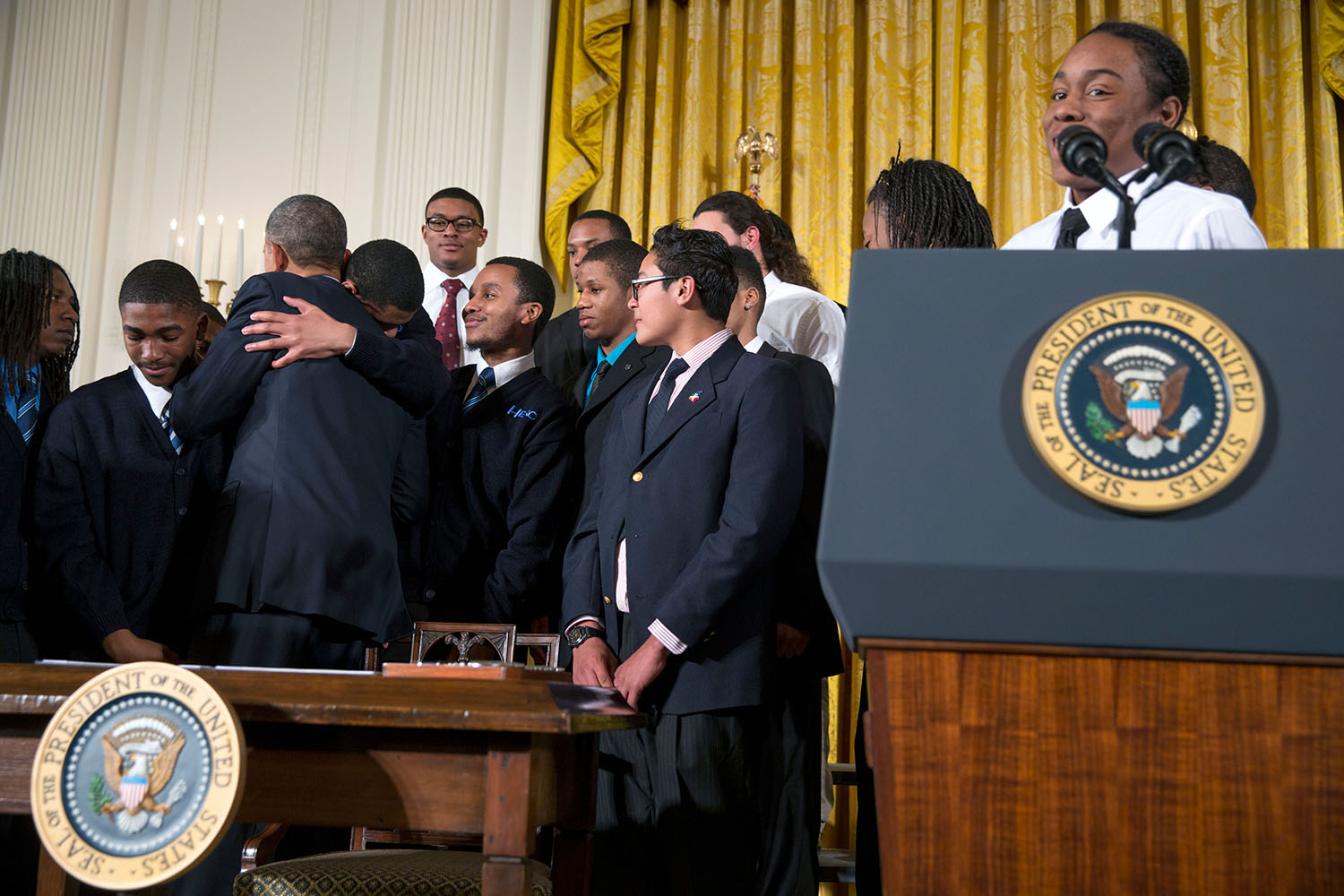 President Obama hugs a participant after signing a Presidential Memorandum establishing the My Brother's Keeper Task Force