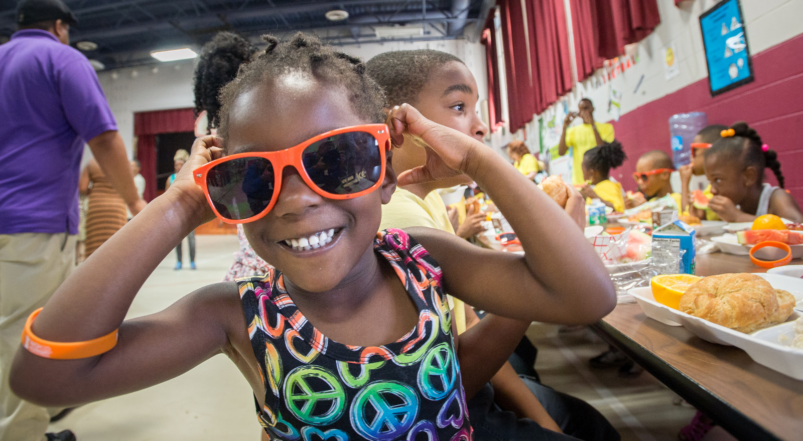 A girl at lunch provided through assistance from the USDA Food Nutrition Service (FNS)