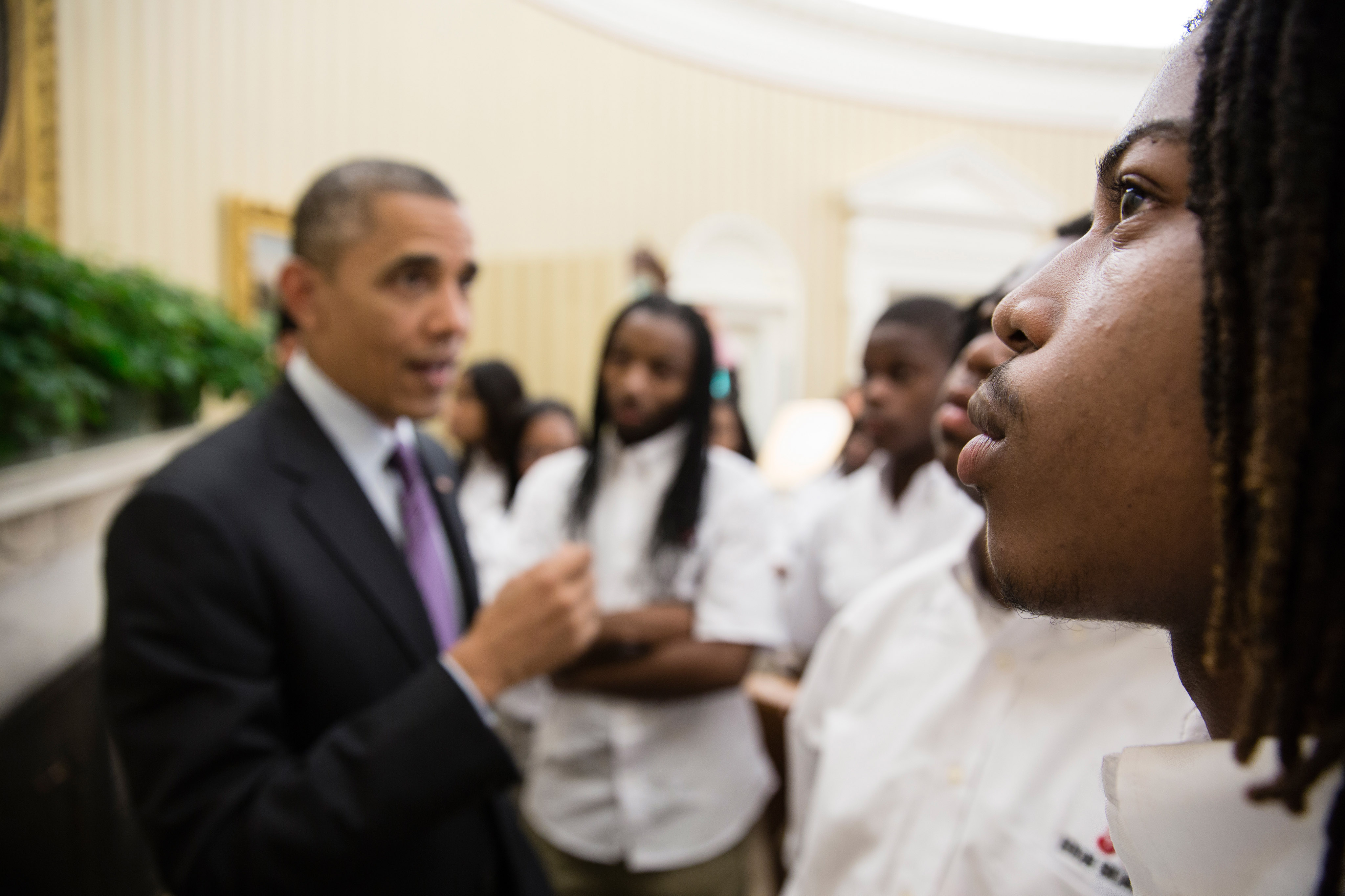 A student eyes the Emancipation Proclamation as the President gave students from William R. Harper High School in Chicago a tour of the Oval Office.