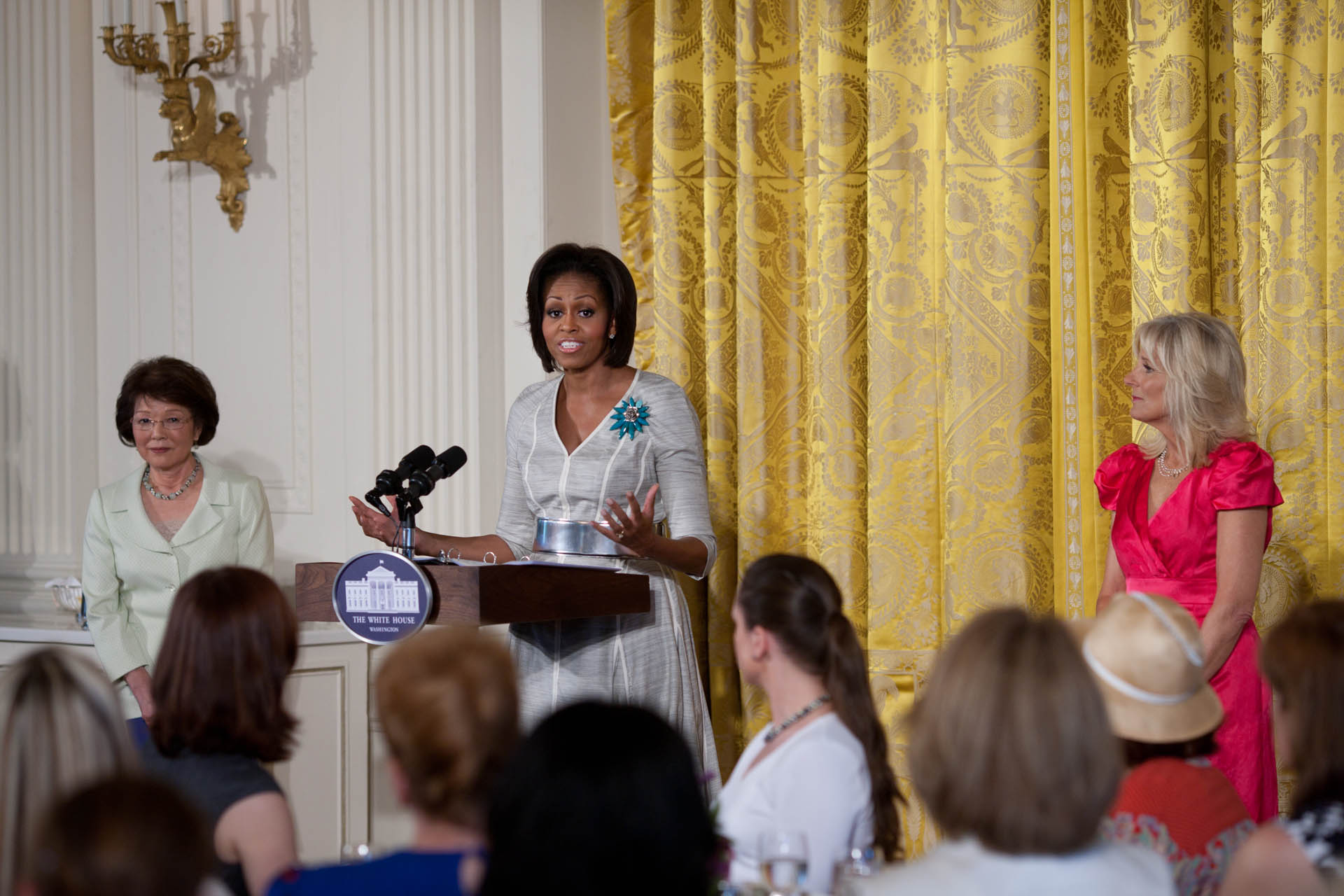 First Lady Michelle Obama addresses military spouses, relatives and friends in the East Room of the White House for a Mother's Day Tea Party 