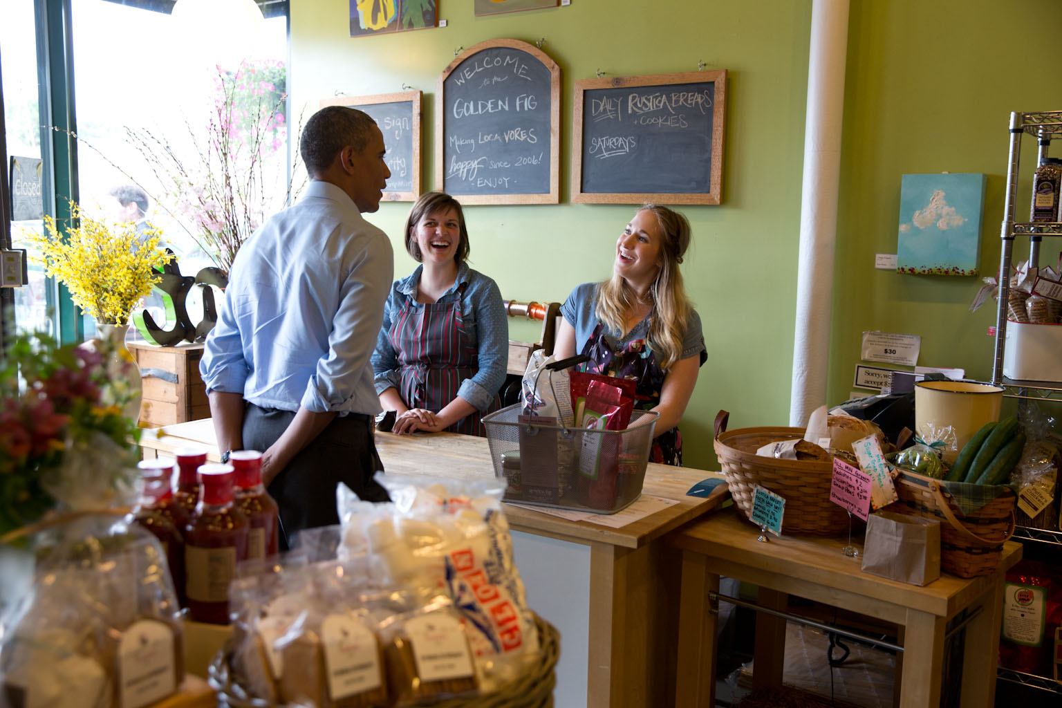 President Barack Obama talks with staff during a stop at the Golden Fig in St. Paul, Minn., June 26, 2014. 