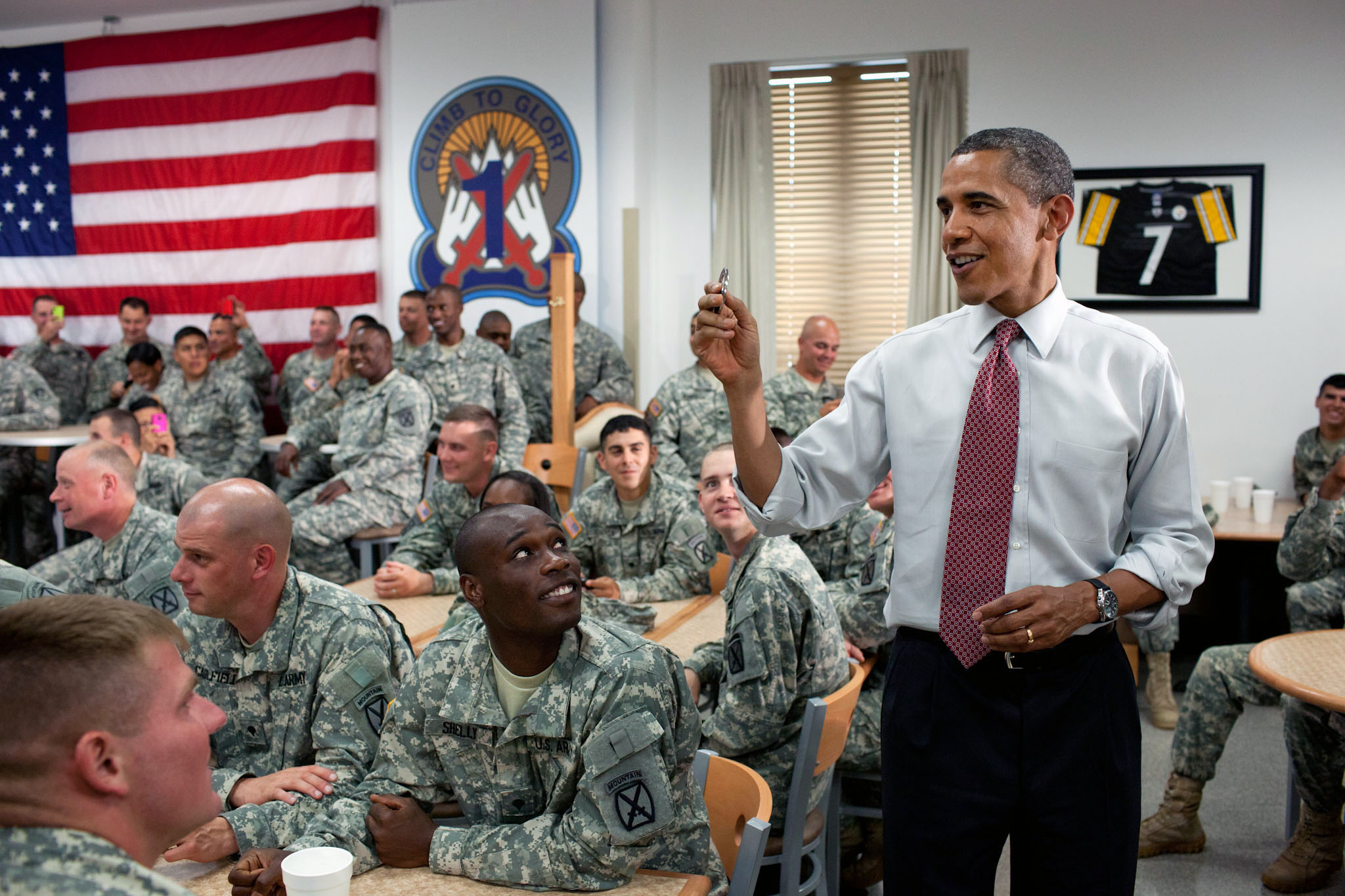 President Barack Obama holds up a coin