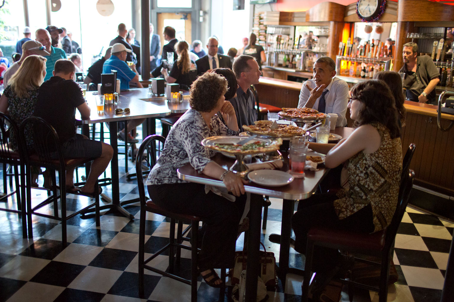 President Barack Obama has a pizza dinner with local residents who had written him letters, in Denver, Colorado, July 8, 2014.