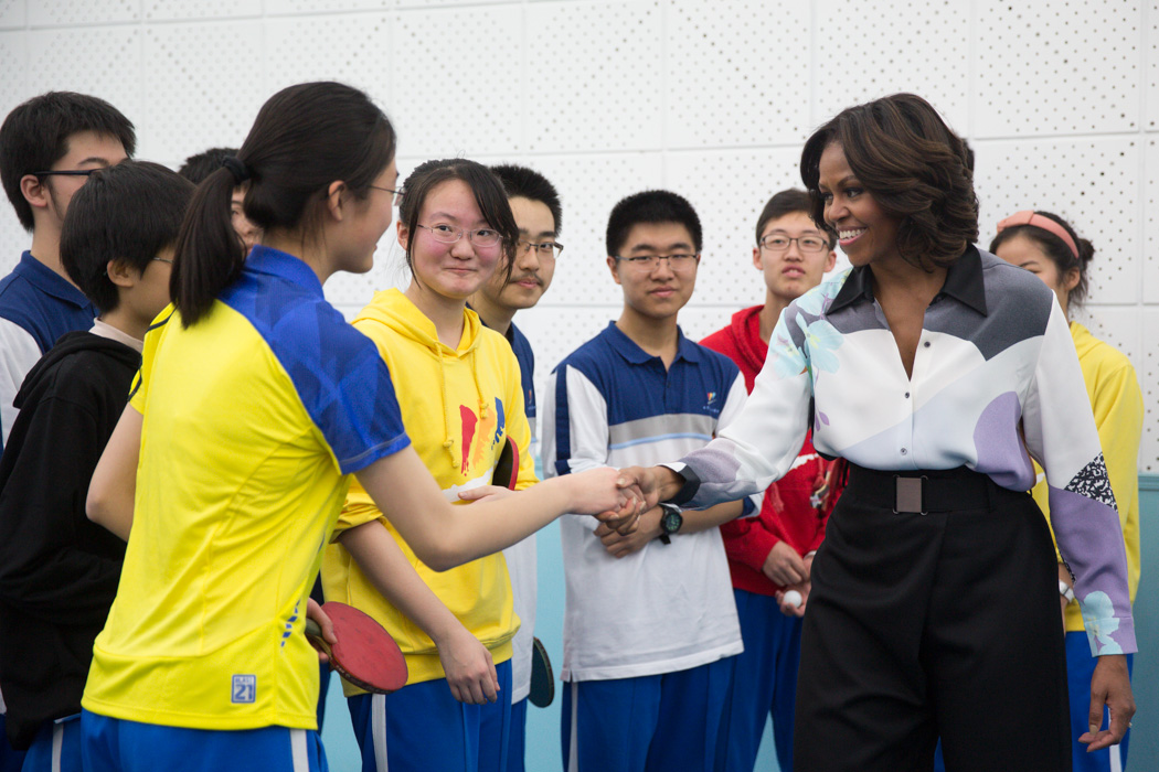 First Lady Michelle Obama greets students after playing ping pong at the Beijing Normal School in Beijing, China