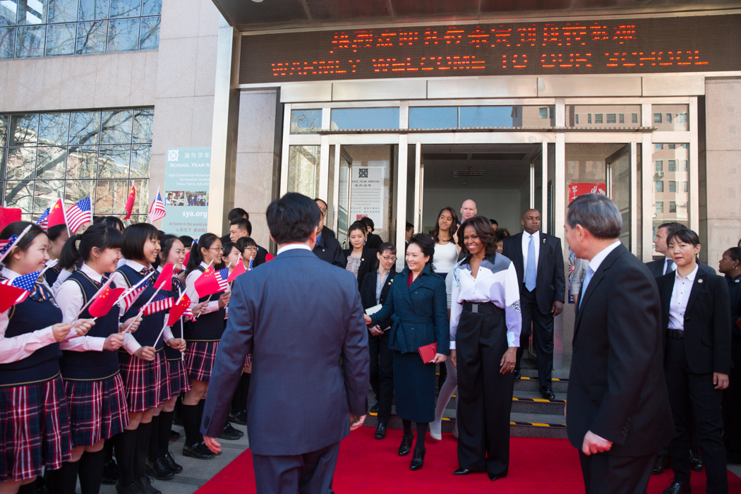 First Lady Michelle Obama and Madam Peng are greeted by a group of students as they leave the Beijing Normal School in Beijing, China