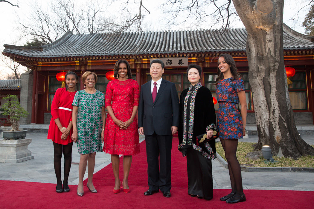First Lady Michelle Obama, along with daughters Sasha, Malia and her mother Marian Robinson, visit with President Xi Jinping of the People's Republic of China and Madam Peng in the courtyard of the Diaoyutai State Guesthouse in Beijing, China