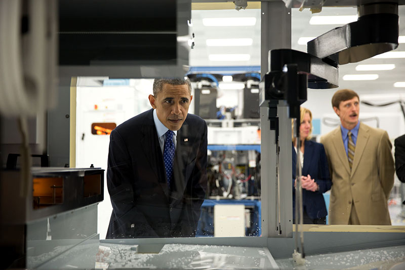 President Barack Obama views equipment during a tour of Applied Materials