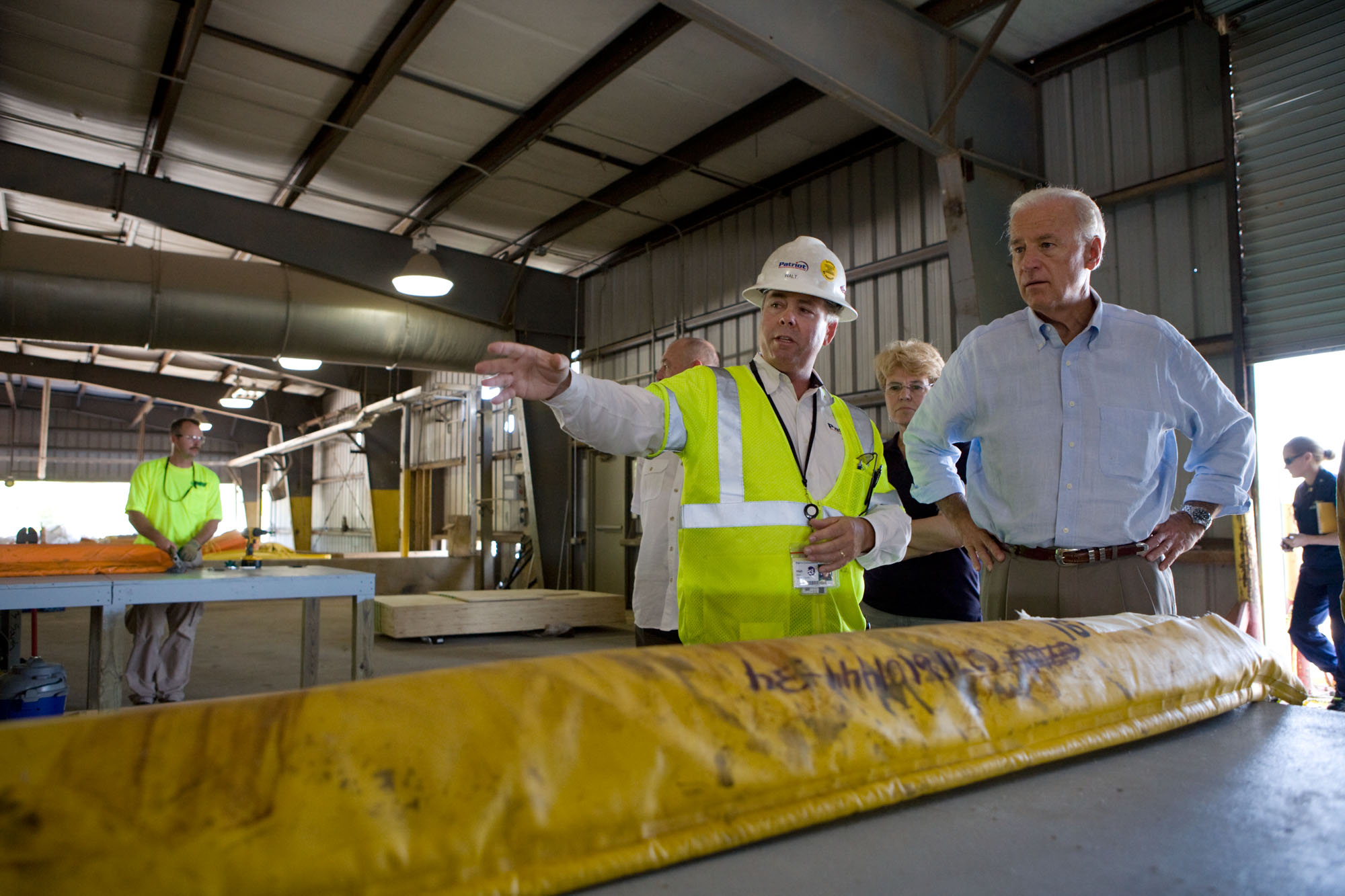 Vice President Joe Biden is led on a tour of the boom repair area