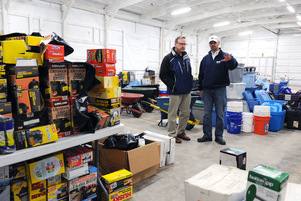 Associate Pastor Ben Davidson, right, of Bethany Community Church shows Rev. David Myers, Senior Advisor to the FEMA Administrator/Director Center of Faith-based & Neighborhood Partnerships, supplies