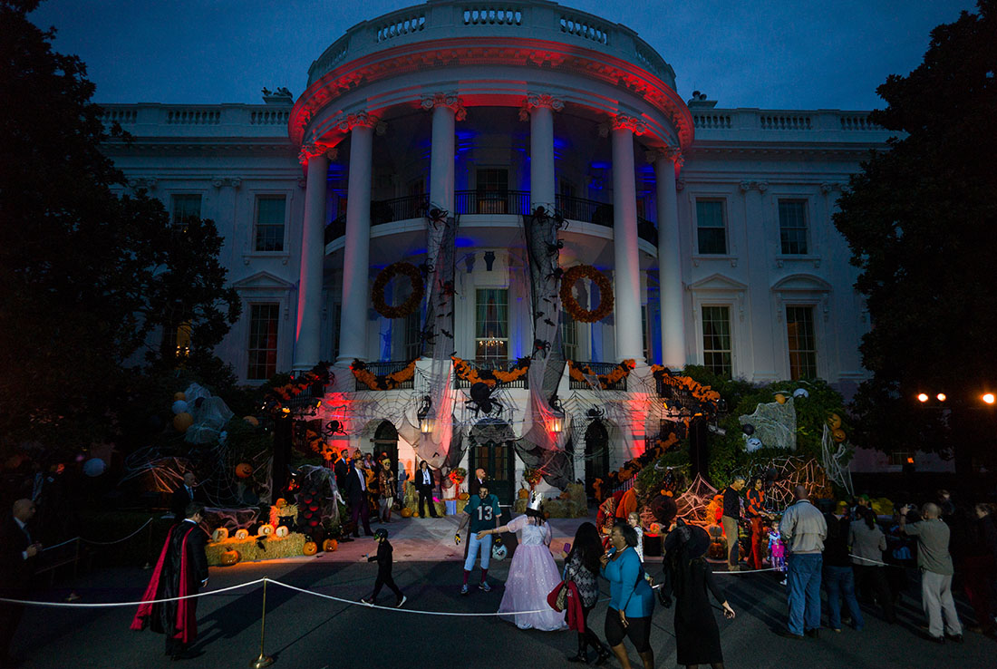 President Barack Obama, First Lady Michelle Obama and Mrs. Marian Robinson hand out Halloween treats to local children