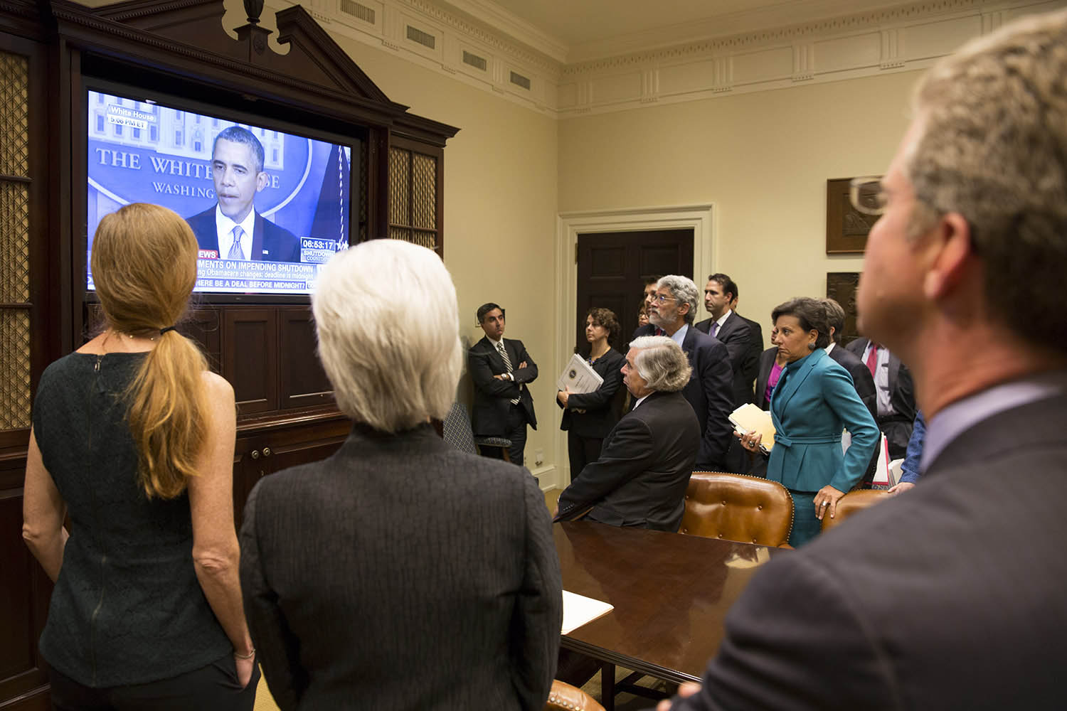 Members of the Cabinet watch as President Obama makes a televised statement on a possible government shutdown