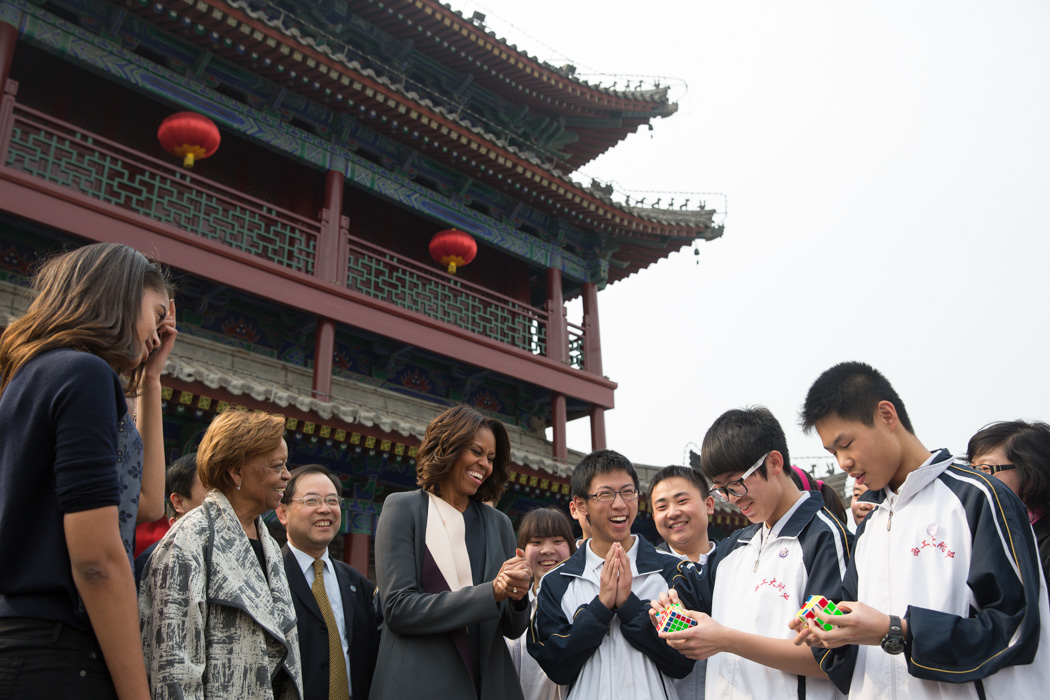 First Lady Michelle Obama, Sasha, Malia and Marian Robinson watch students perform a Rubik's Cube demonstration during their visit the Xi'an City Wall, China