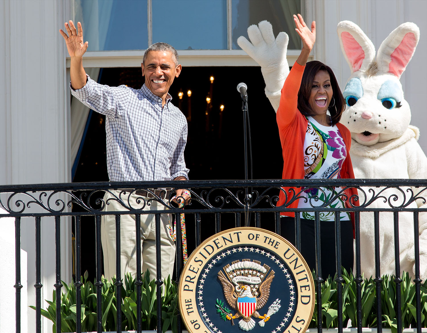 President Barack Obama and First Lady Michelle Obama and the Easter Bunny wave from the Blue Room Balcony 