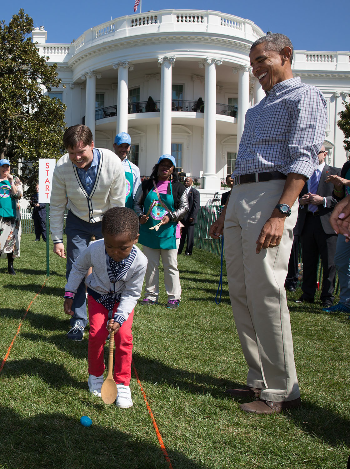 President Barack Obama watches a young boy roll an egg during the annual Easter Egg Roll 