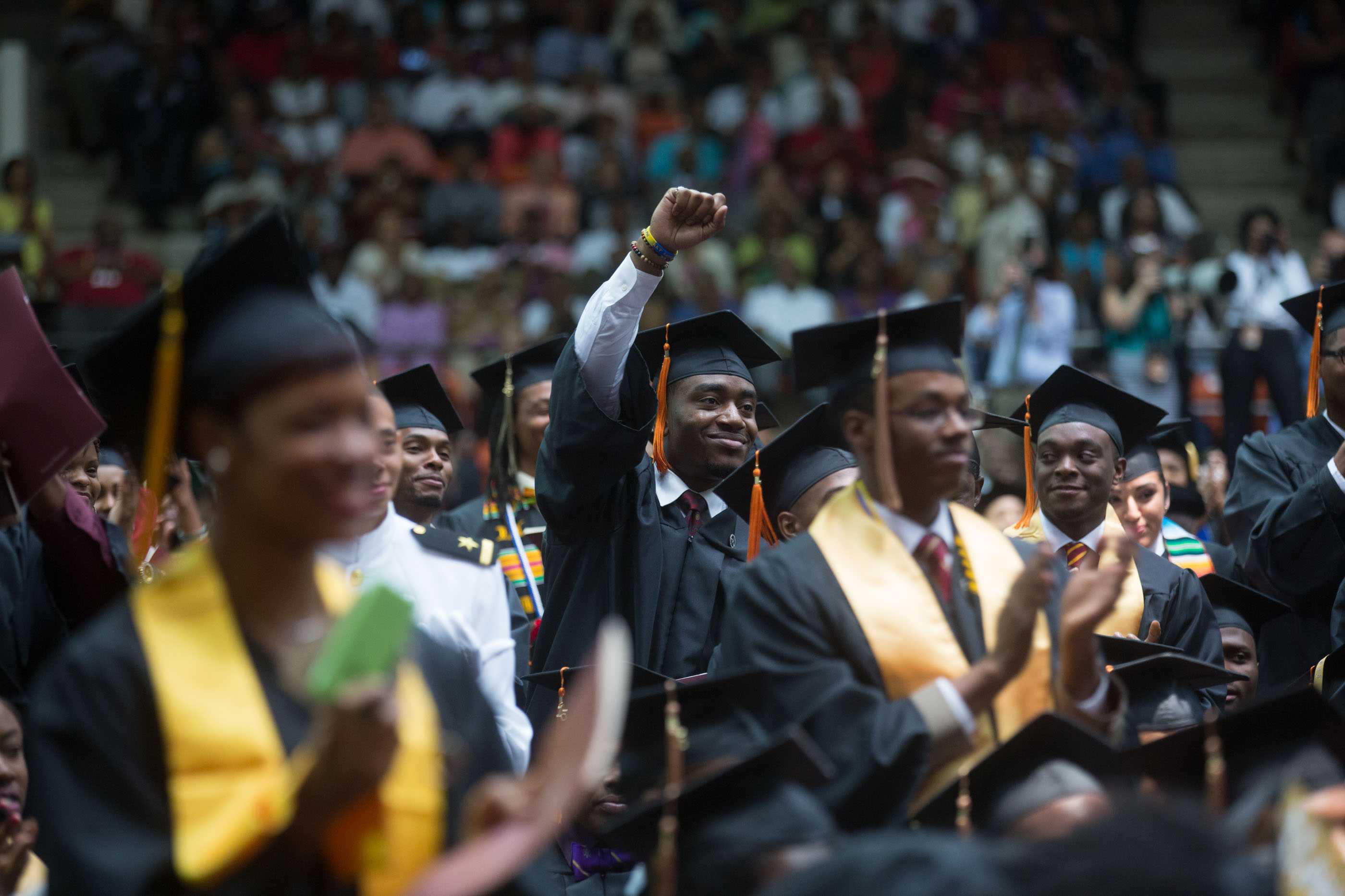 A student waves during the First Lady's remarks at Tuskegee