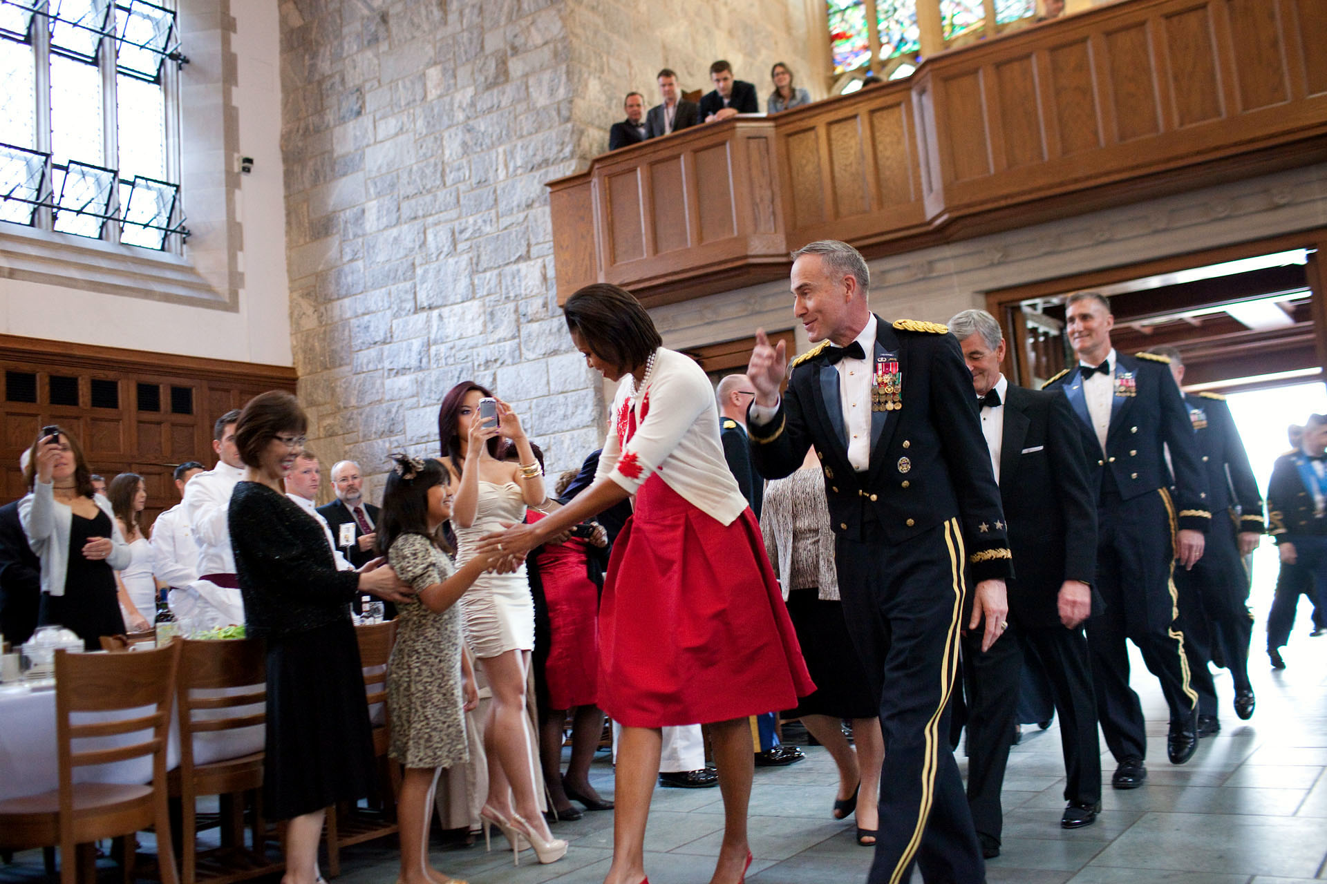 First Lady Michelle Obama shakes hands with a young girls as she enters the West Point Graduation