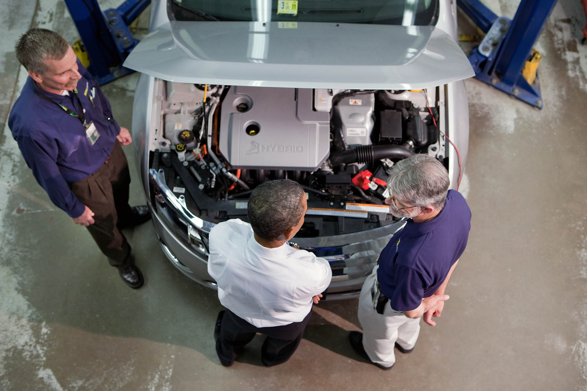 President Barack Obama looks under the hood of a hybrid car 