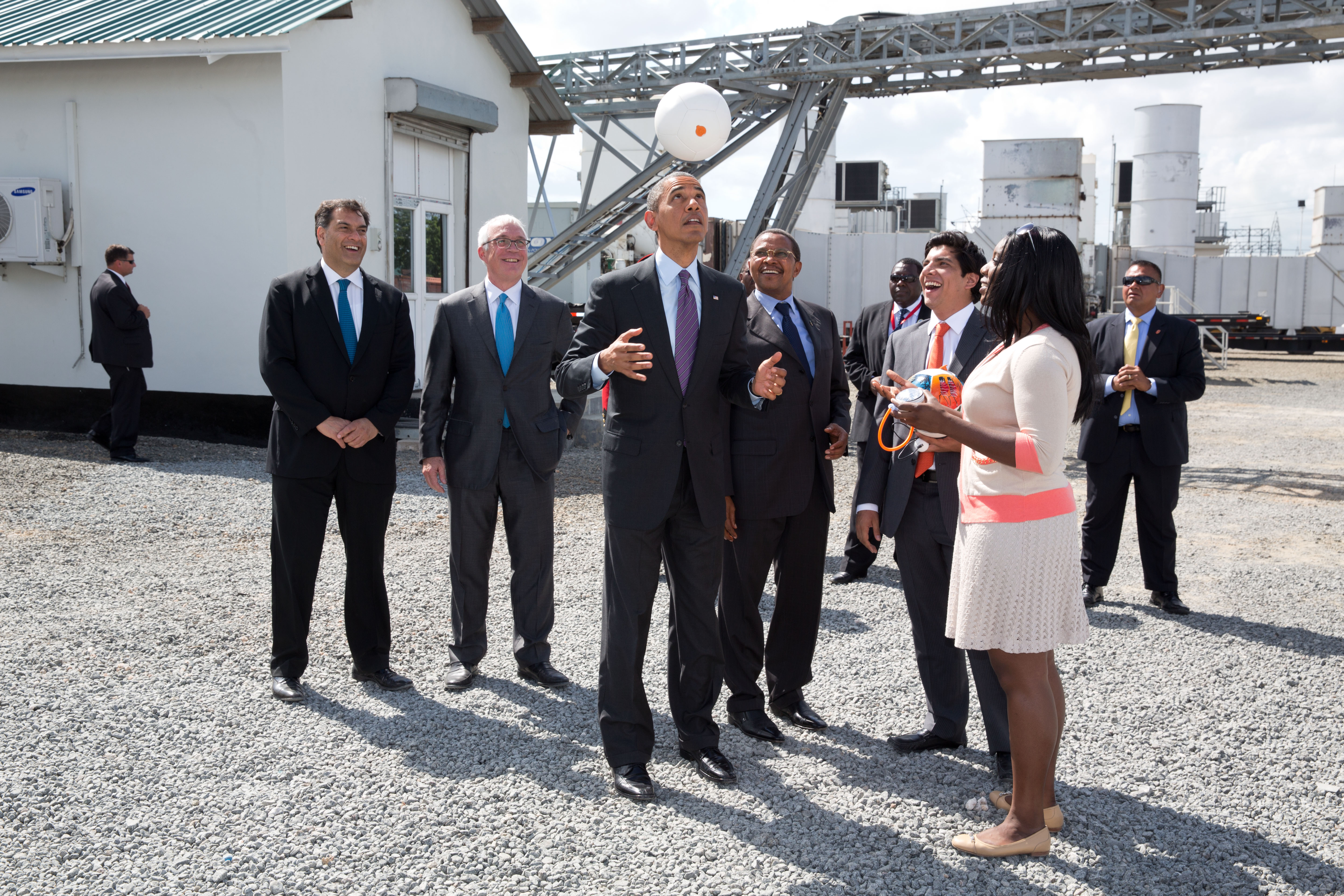 President Barack Obama tosses a Soccket ball in the air at the Ubongo Power Plant in Dar es Salaam