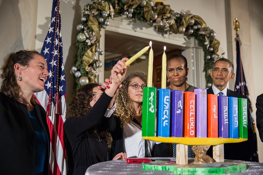 President Obama, First Lady Michelle Obama, Rabbi Bradley Artson, and students from Hand in Hand participate in a Menorah lighting