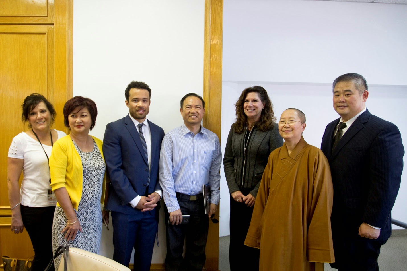 Martha Flores, Susan M Curda, USCIS Officer Brandon Menancio, and Paul Chang (far right) after the presentation