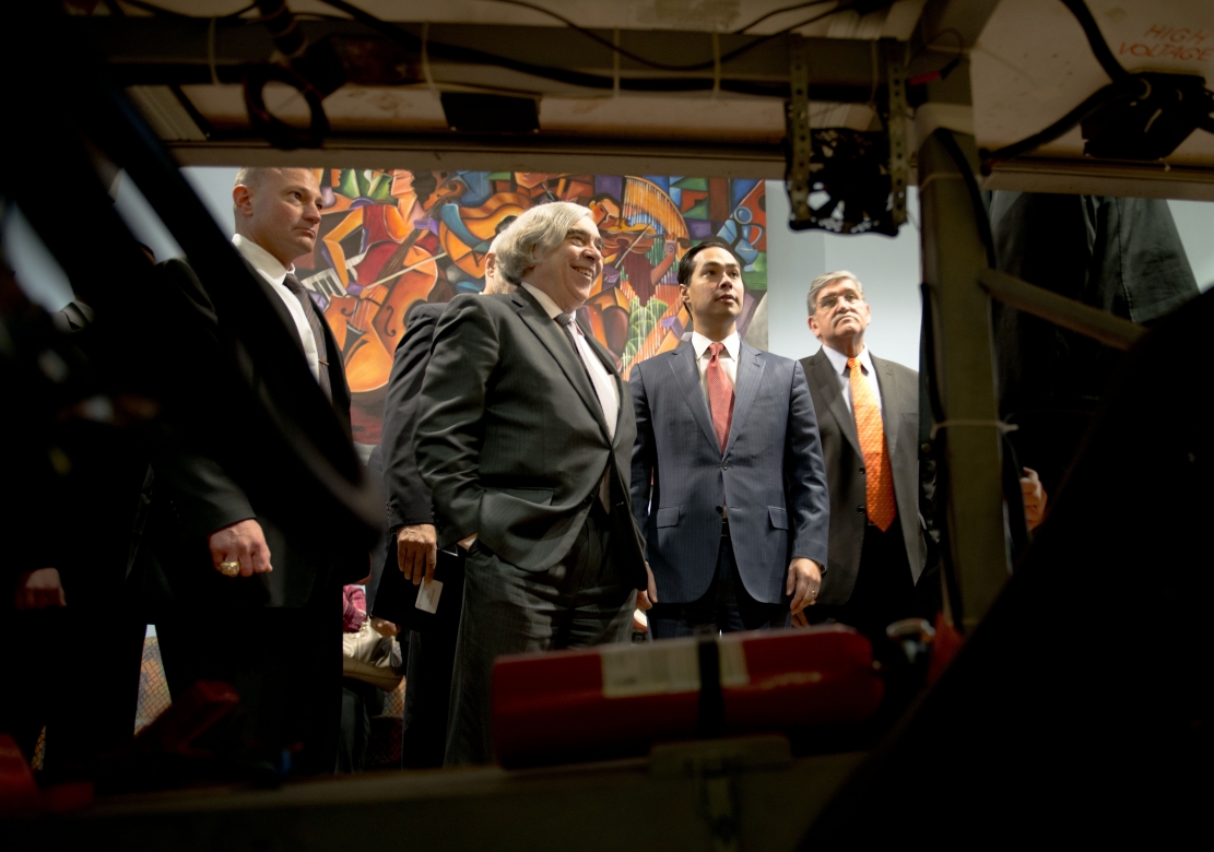 U.S. Secretary of Energy Ernest Moniz, center left, and San Antonio, Texas, Mayor Julián Castro, center right, take a look at a solar car built by students at San Antonio's James Madison High Schoo