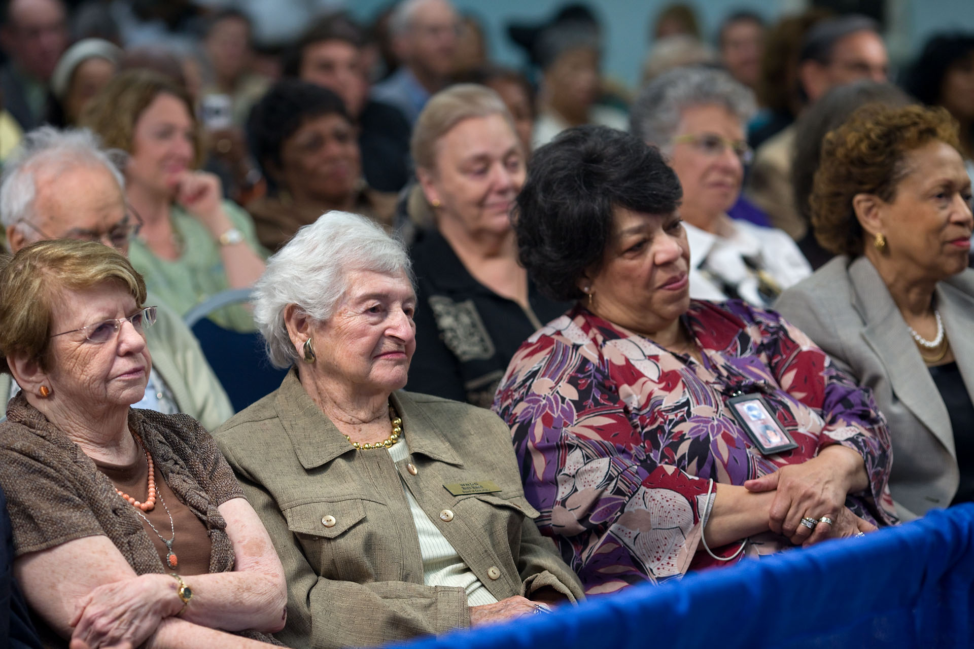 The Audience Listens During a Tele-town Hall Meeting with Senior Citizens 