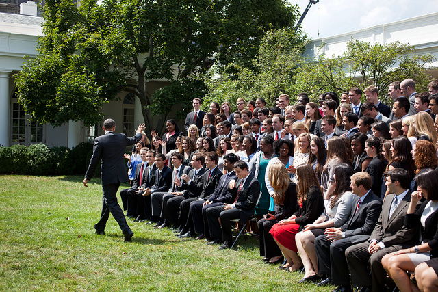 President Obama waves goodbye after talking with summer interns from the White House Internship Program
