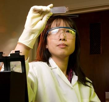 Lawrence Livermore National Laboratory (LLNL) biologist Crystal Jaing holds up a Microbial Detection Array slide. (Photo credit:  Lawrence Livermore National Lab)