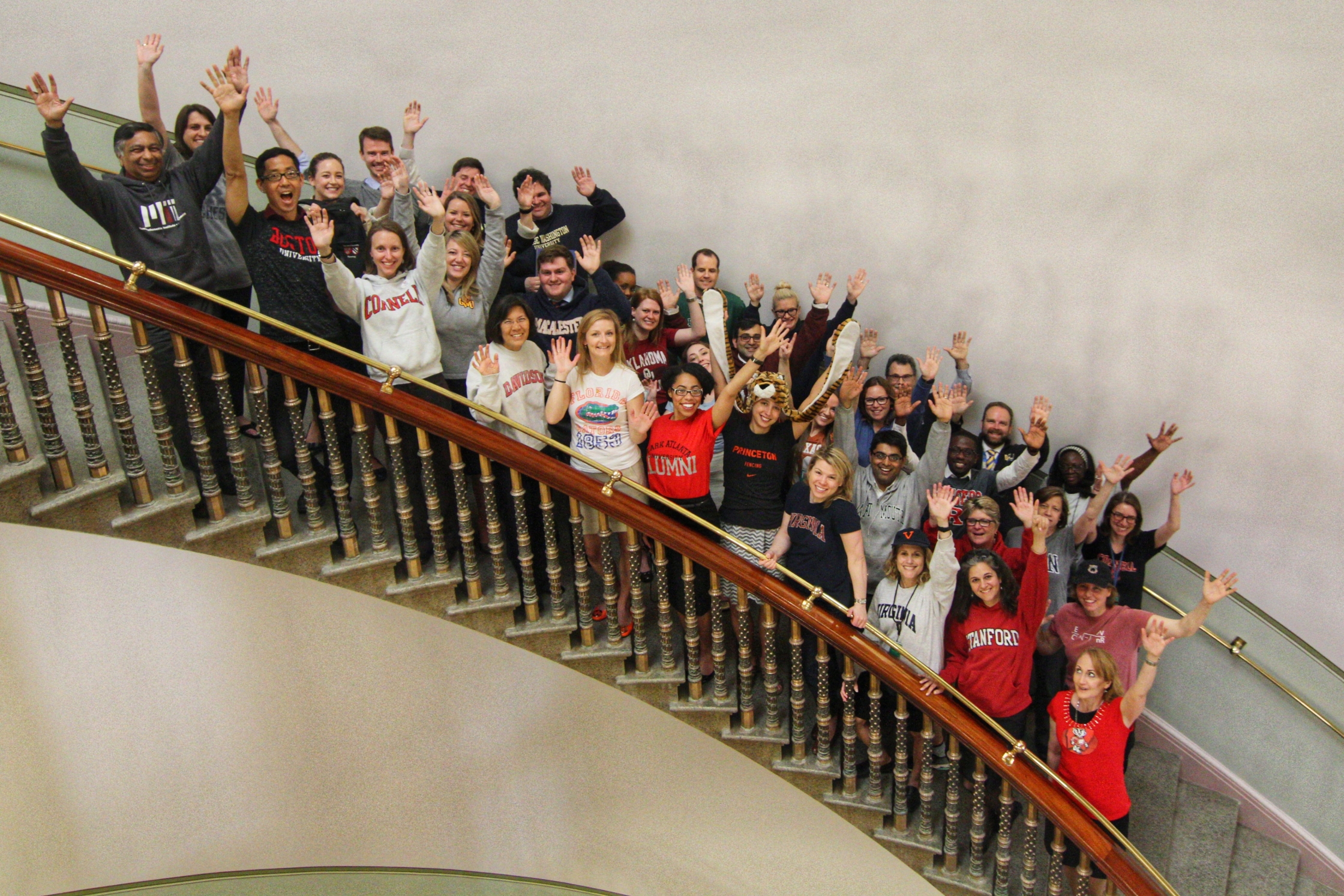 Members of the OSTP team pose in their college gear for #ReachHigher.