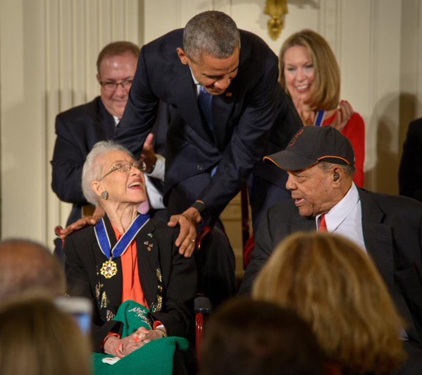 President Barack Obama presents former NASA mathematician Katherine Johnson with the Presidential Medal of Freedom, as professional baseball player Willie Mays, right, looks on, Tuesday, Nov. 24, 2015, during a ceremony in the East Room of the White House in Washington.