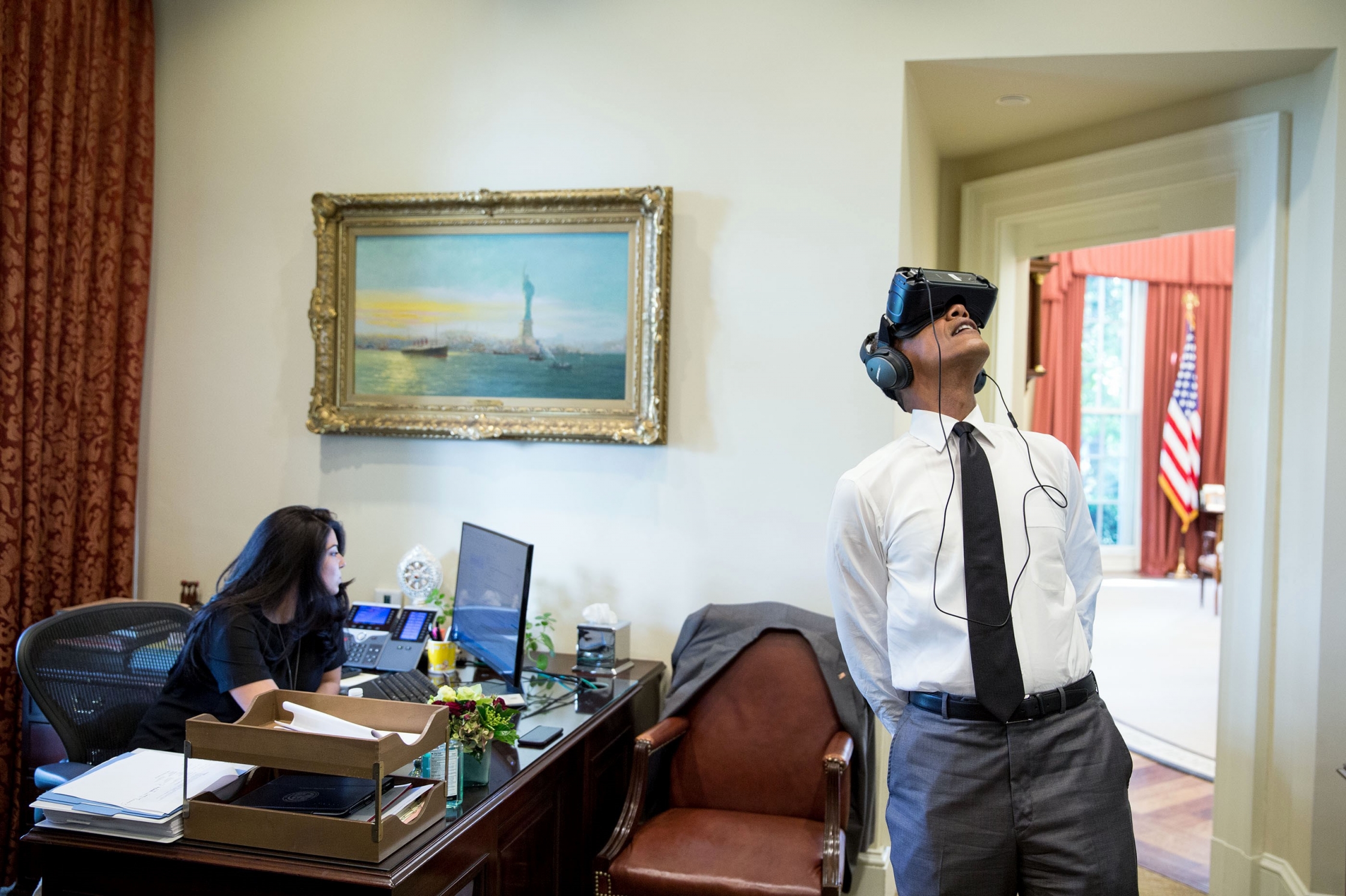 President Barack Obama uses a virtual reality headset in the Outer Oval Office, Aug. 24, 2016. Personal aide Ferial Govashiri sits at her desk at left. (Official White House Photo by Pete Souza)